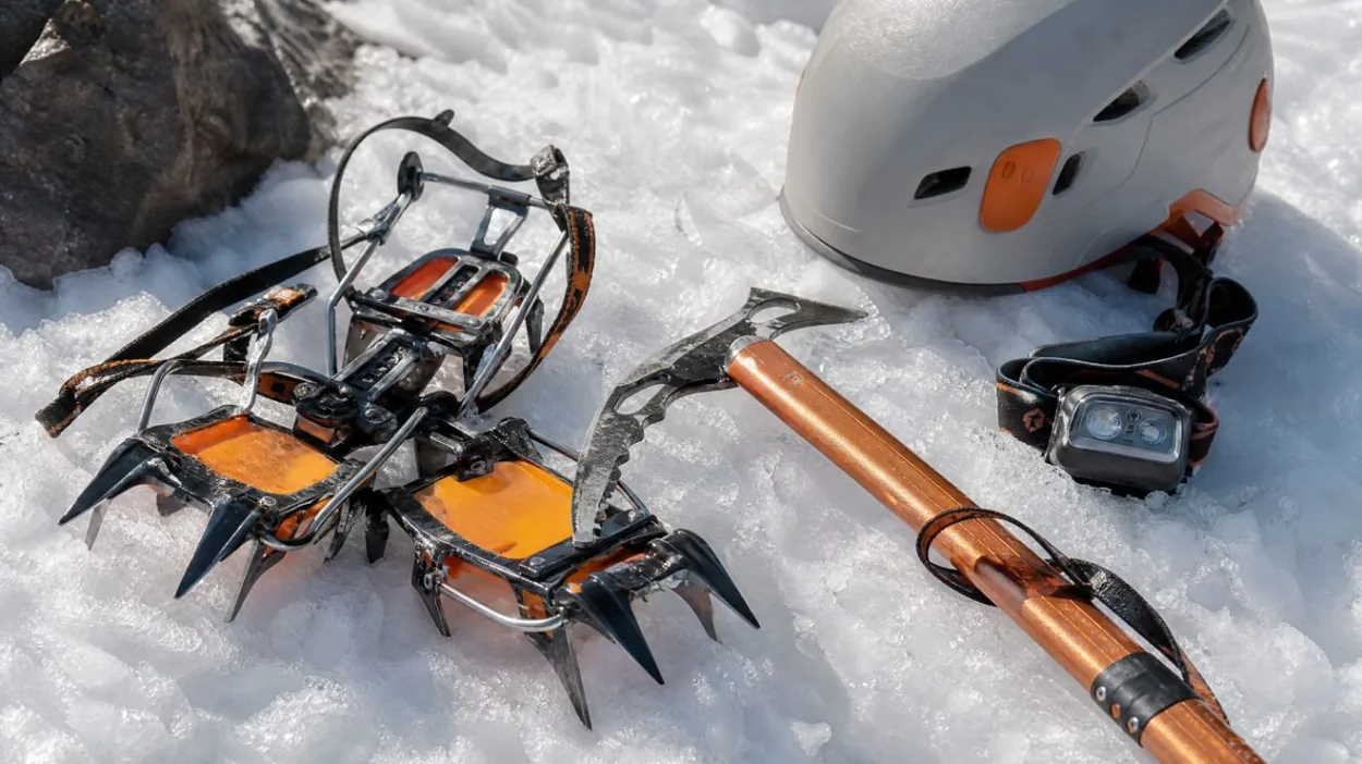 Crampons, an ice axe and a helmet on firm spring snow