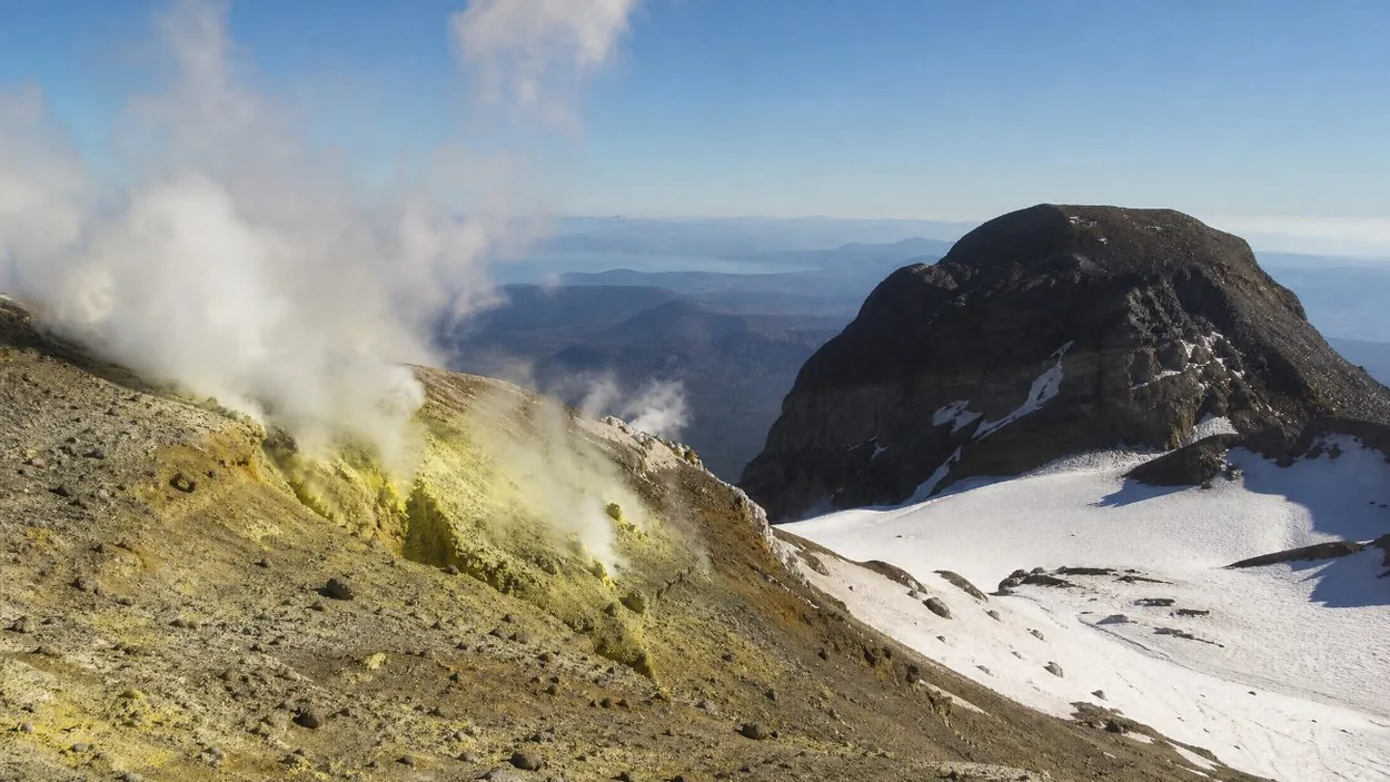 Steam rising from volcanic rock near the snowy crater of Mount Hood
